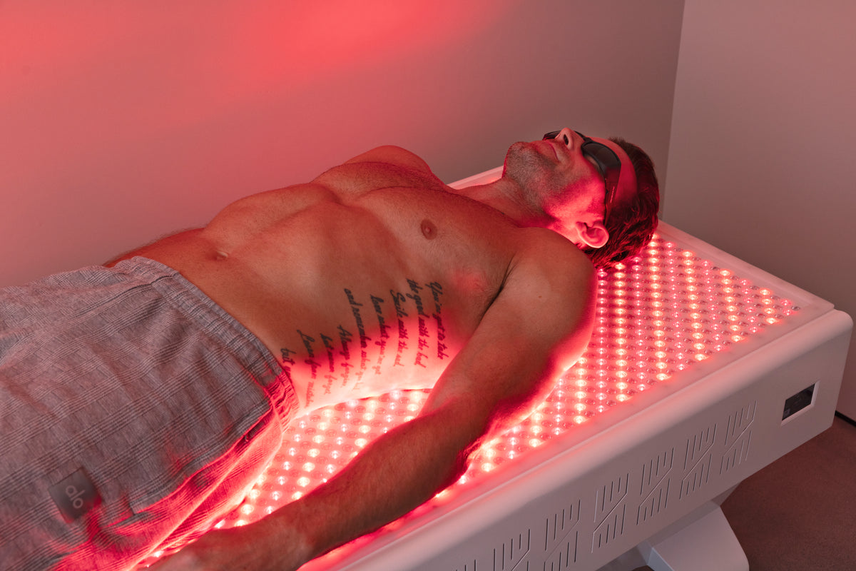 man laying on bottom half of recharge bed